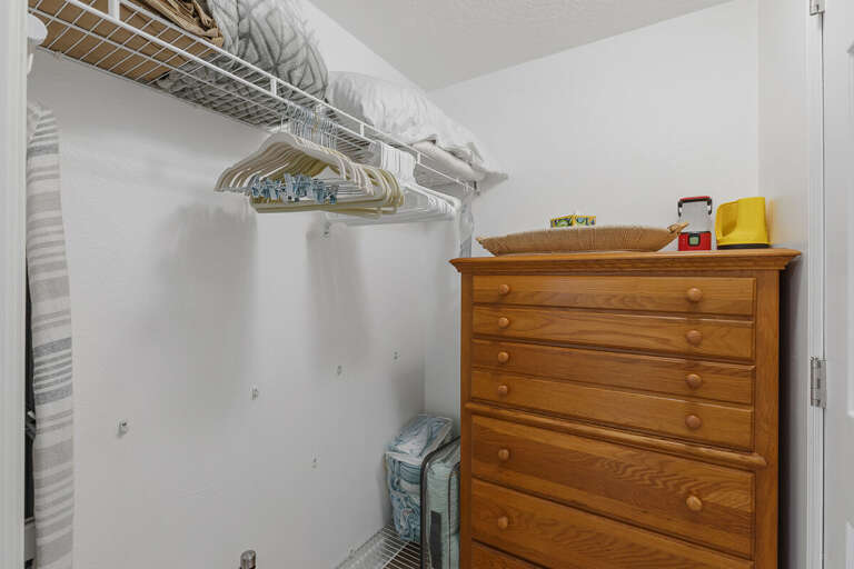 Ample closet space with hangers, shelving, and dresser storage—perfect for organizing your