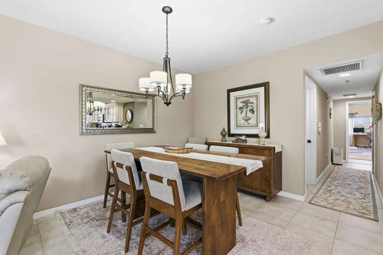 Charming dining space with elegant table seating and warm coastal décor. Ideal for shared meals and memorable moments during your beach stay, just steps from the kitchen and relaxing living areas.