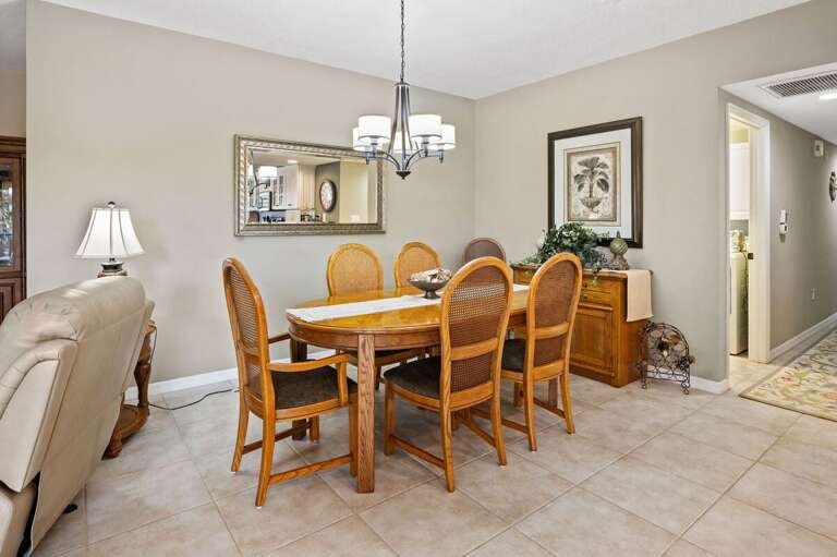 Gather around the warm wood dining table in this inviting coastal retreat. Ideal for family meals after a day at the beach, this bright and comfortable space makes every beach stay feel like home.