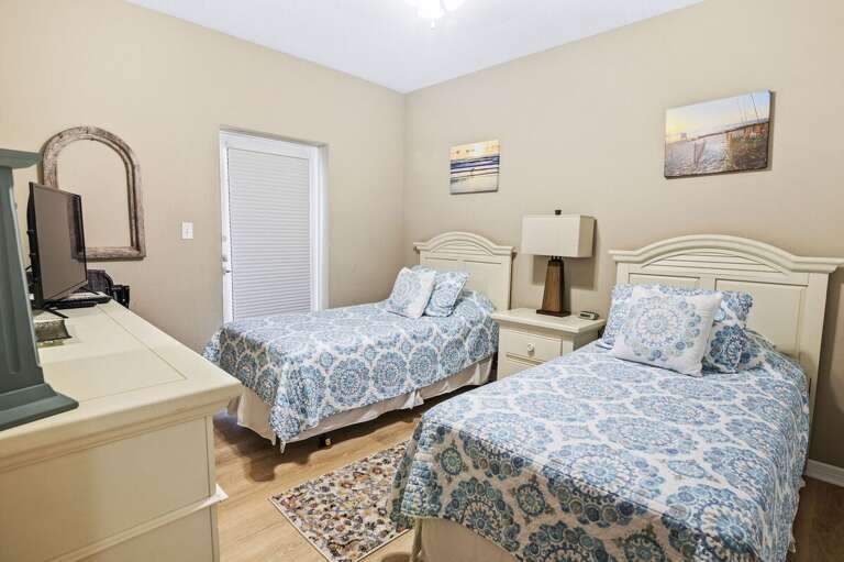 This inviting twin bedroom offers comfortable beds and coastal-inspired décor, perfect for kids or