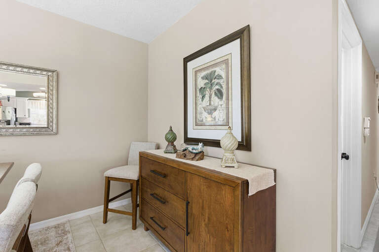 Thoughtfully styled accent area with elegant storage, coastal décor, and warm finishes. Adds charm