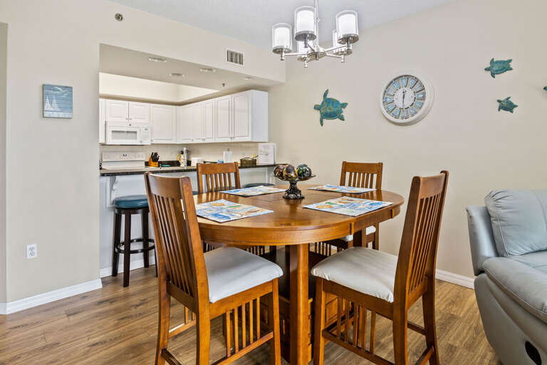 Gather for meals during your beach stay in this inviting coastal dining area with seating for four and easy access to the fully equipped kitchen. A perfect space to plan your next day of sun and sand.