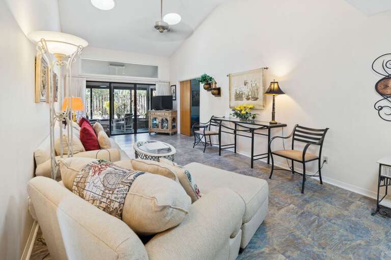 Unwind in this bright, open-concept living area with cozy seating, vaulted ceilings, and private