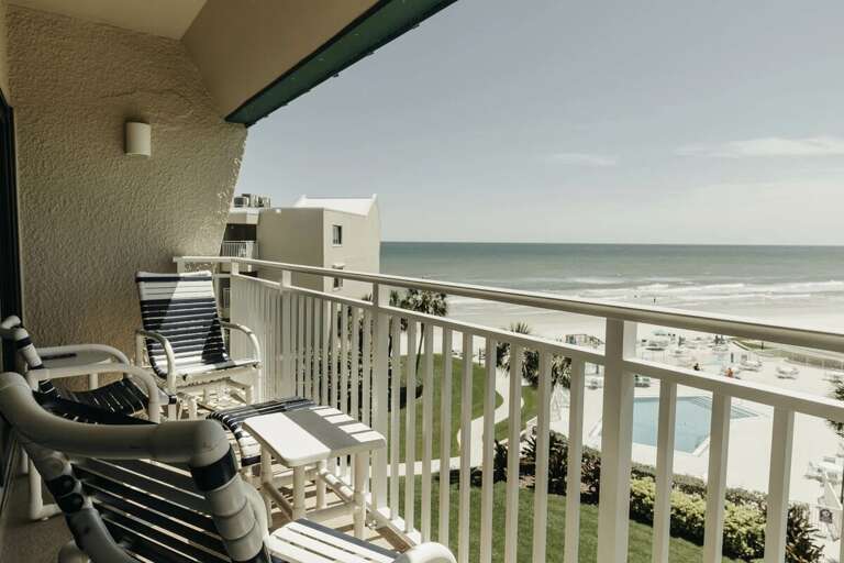 Enjoy breathtaking ocean views from this private balcony at your beach stay. Relax in comfortable