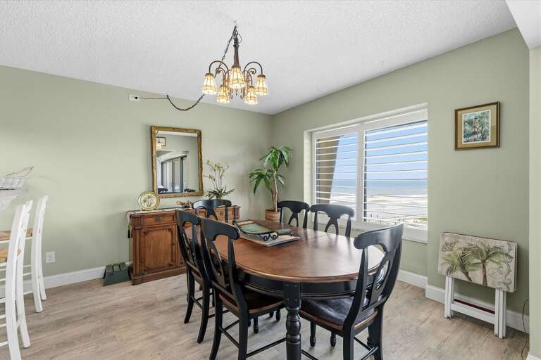 Enjoy meals with beautiful ocean views in this inviting coastal dining space featuring natural light and beach-inspired charm. Perfect for a relaxing beach stay just steps from the sand and surf.