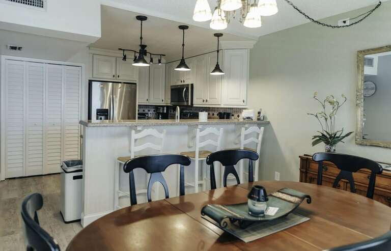 Enjoy meals together in this inviting beach stay dining area featuring a spacious table and convenient breakfast bar. Perfect for gathering, dining, and relaxing after a fun-filled day by the beach.