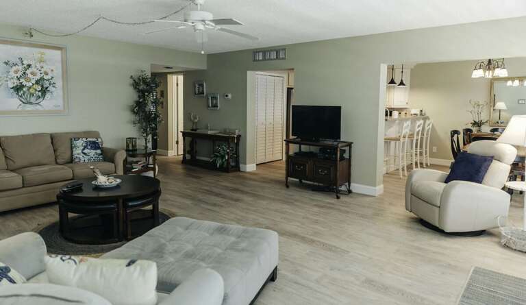 This spacious beach stay features an open-concept living and dining area with comfortable seating,