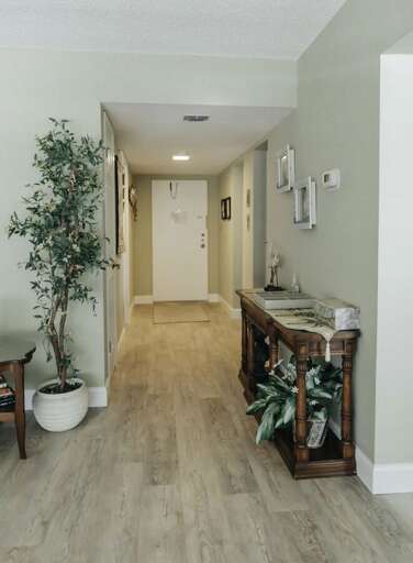 Step into this inviting beach stay featuring a bright and welcoming entryway with coastal décor and