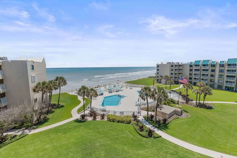 Take in stunning oceanfront views overlooking the resort pool, palm-lined grounds, and sandy shoreline. Perfect for a relaxing beach stay with direct beach access and resort-style amenities.