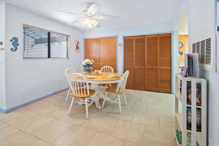 Enjoy meals together in this bright beach stay dining area featuring a charming round table and coastal accents. A welcoming space to gather, plan your day, and unwind after time spent at the beach.