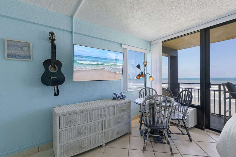 Enjoy meals with a view in this charming beach stay dining area, featuring coastal décor and direct access to a private oceanfront balcony. Perfect for relaxing mornings or sunset dinners by the sea.