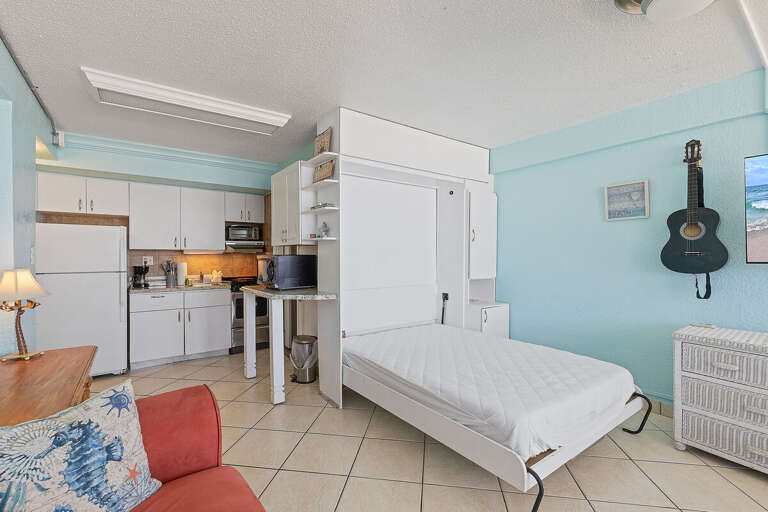 This inviting beach stay studio features a convenient Murphy bed, full kitchen, and coastal décor. Maximize comfort and space while enjoying a relaxing getaway just steps from the beach.