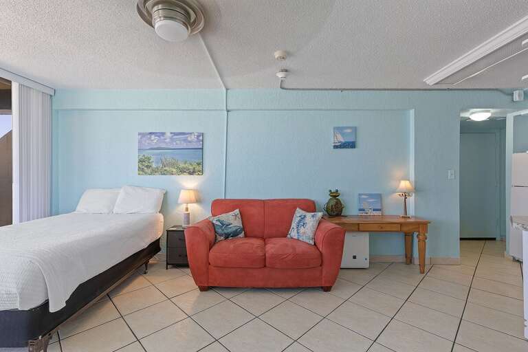 Unwind in this inviting beach stay featuring a comfortable bed, cozy seating, and coastal décor. The open layout offers a relaxing space to recharge after a day enjoying the sun, sand, and ocean.