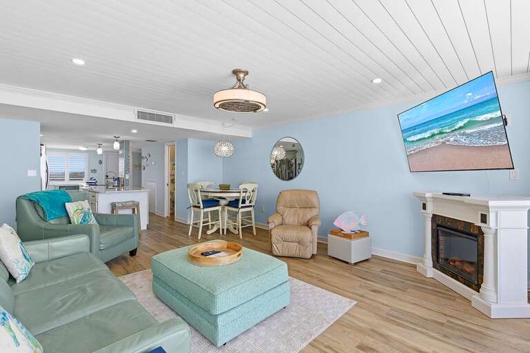 Relax in this spacious beach stay living area with comfortable seating, coastal décor, and open-concept design. Perfect for unwinding, watching TV, or gathering after a fun day by the beach.