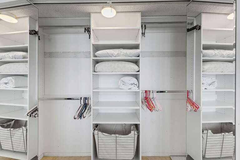 Stay organized during your beach stay with this spacious walk-in closet featuring ample shelving, hanging space, and storage for all your vacation essentials and beach gear.