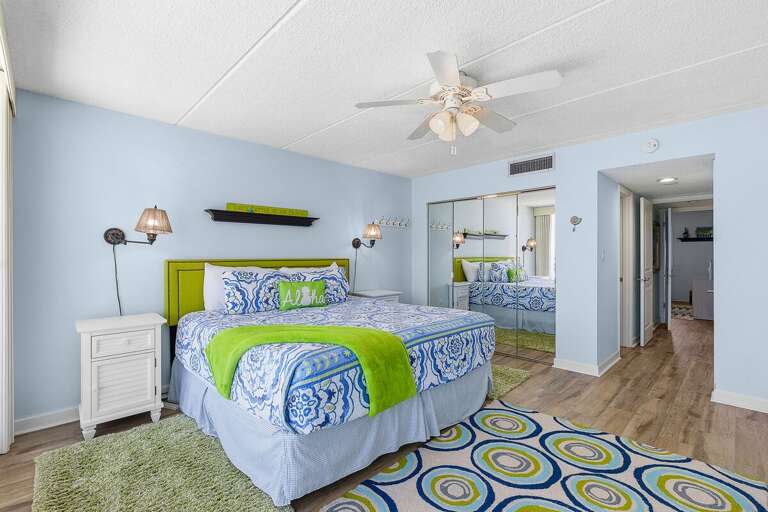 Unwind in this spacious beach stay bedroom featuring cozy coastal décor, plush bedding, and ample space to relax. A peaceful retreat after enjoying sun-filled days by the ocean.