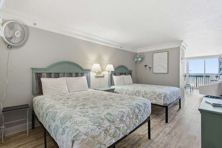 Relax and unwind in this beach stay bedroom featuring two comfortable beds and coastal décor. Enjoy