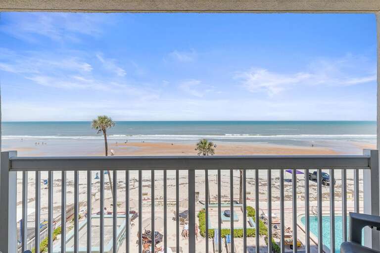 Take in sweeping oceanfront views from your private balcony overlooking the beach and pool. This