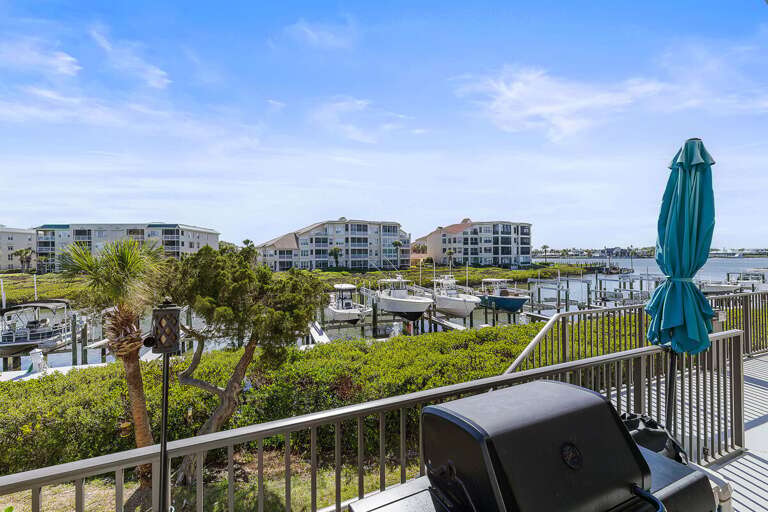 Elevate your beach stay with this private balcony overlooking the marina, boats, and coastal scenery. Enjoy outdoor seating, fresh ocean air, and the perfect spot to relax after a day at the beach.