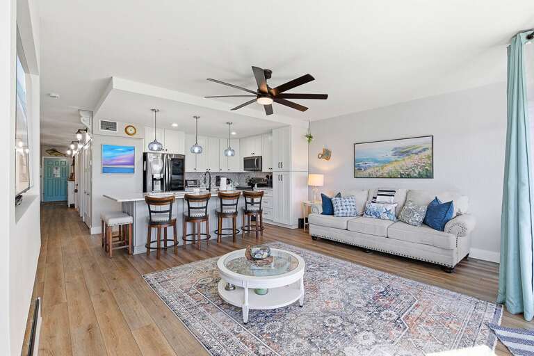 Enjoy a relaxing beach stay in this spacious open-concept condo featuring a modern kitchen, bar