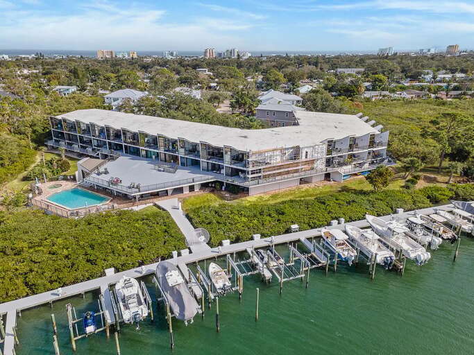 Experience the ultimate beach stay at this waterfront condo featuring a private dock, boat slips,