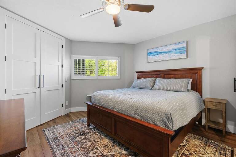 Rest easy in this inviting beach stay bedroom featuring a comfortable bed, calming coastal décor,