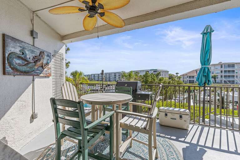 Savor your beach stay on this private balcony featuring outdoor dining, a grill, and scenic coastal