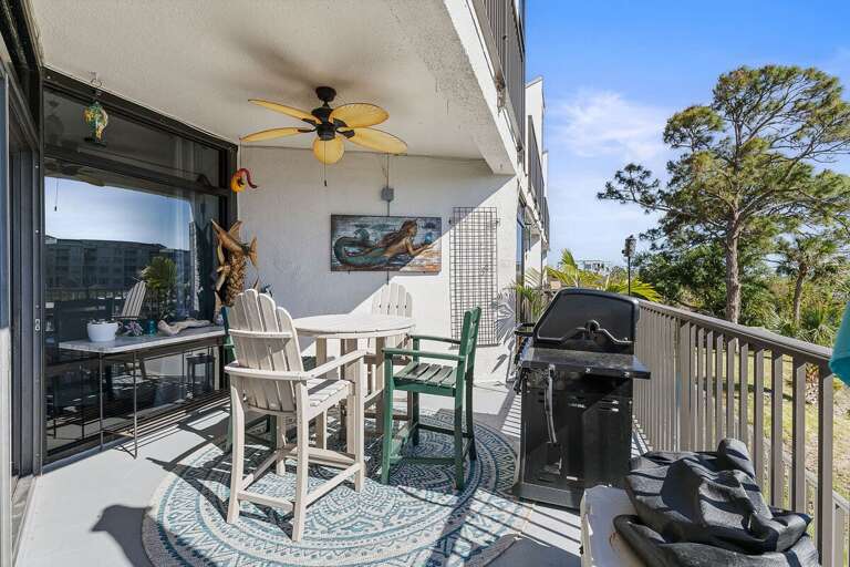 Make the most of your beach stay on this inviting balcony featuring outdoor dining, a grill, and coastal décor. Enjoy fresh ocean breezes and a relaxing space to unwind after a day at the beach.