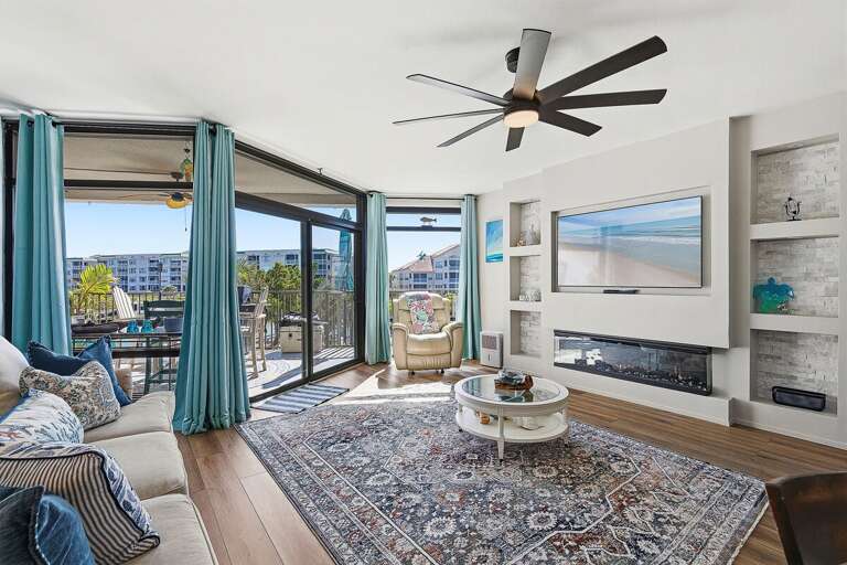 Unwind in this inviting beach stay featuring a bright living room, coastal décor, fireplace, and