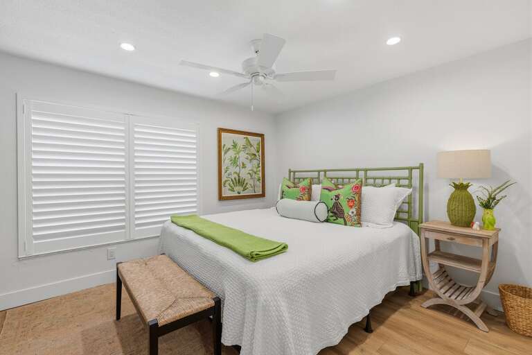 Enjoy restful nights in this inviting beach stay bedroom featuring soft coastal décor, plush bedding, and a bright relaxing atmosphere perfect for unwinding after a sunny beach day.