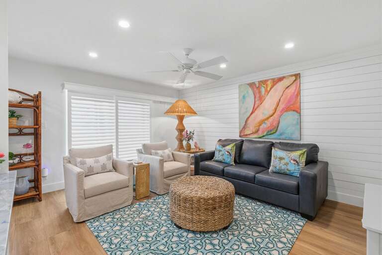 Relax in this inviting beach stay living room featuring coastal décor, comfortable seating, and a bright open layout—perfect for unwinding after a sunny day at the beach or pool.
