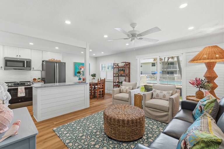 Relax in this stylish beach stay featuring an open-concept living area, modern kitchen, coastal décor, and easy access to the pool—perfect for a fun and relaxing seaside getaway.