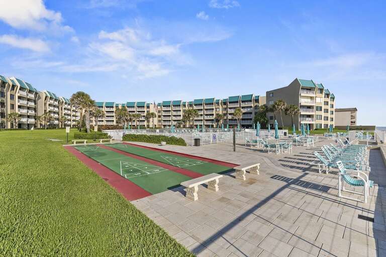 Enjoy resort-style amenities including shuffleboard courts, spacious sun deck seating, and a sparkling oceanfront pool. Perfect for a fun and relaxing beach stay just steps from the shoreline.