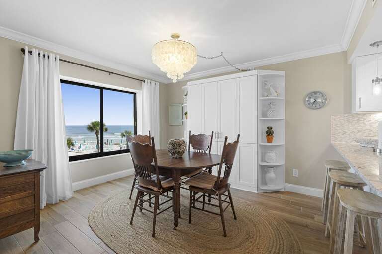 Gather for meals with stunning ocean views in this bright coastal dining area featuring