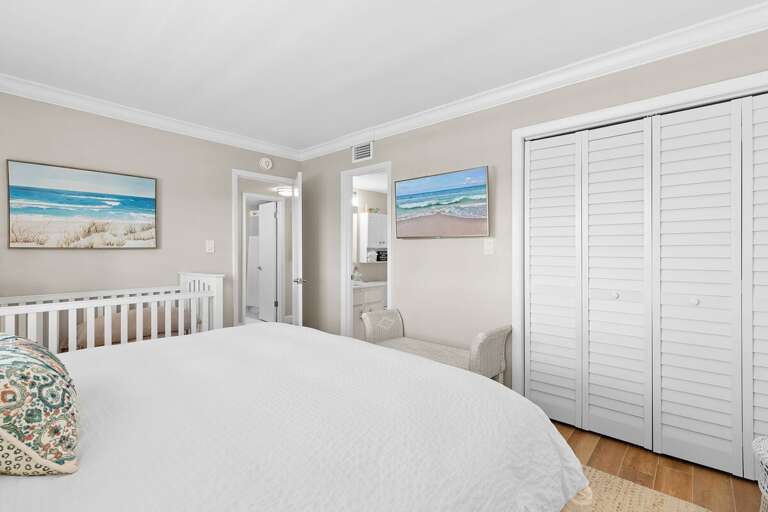 Recharge in this serene beach stay bedroom featuring soft coastal décor, plush bedding, ample storage, and family-friendly touches for a comfortable and relaxing seaside getaway.