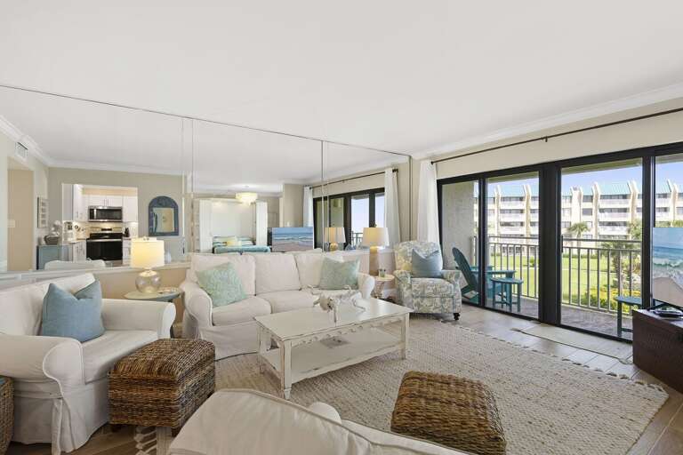 Relax in this inviting beach stay featuring a spacious coastal living room, comfortable seating, and