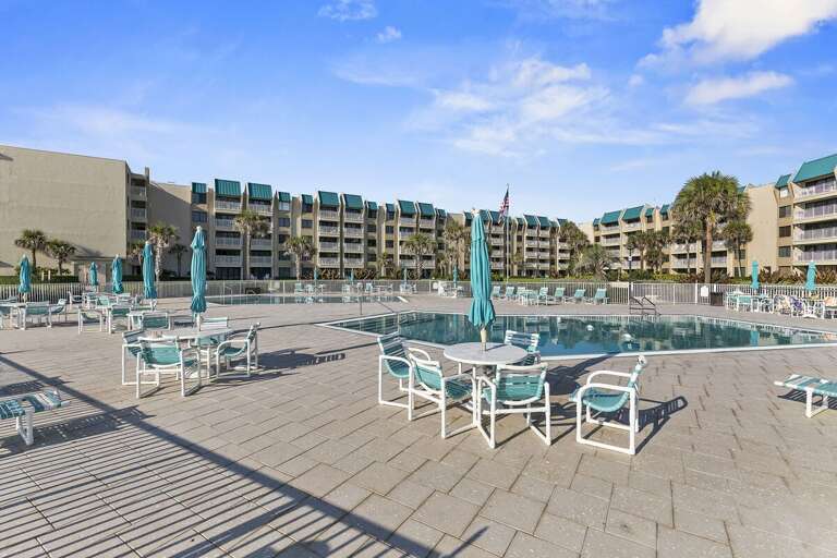Relax poolside at this oceanfront resort featuring spacious sun decks, lounge seating, and coastal