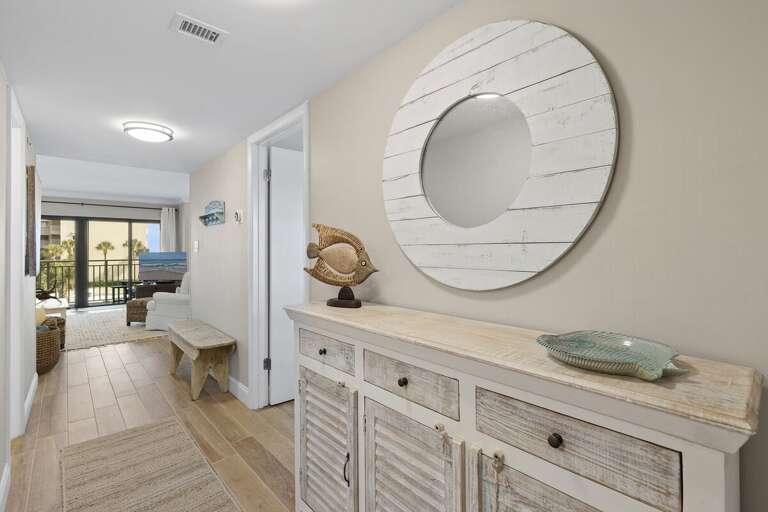 Step into your relaxing beach stay with this bright coastal-inspired condo entryway featuring