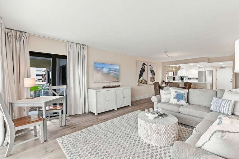 Relax in this bright open-concept living space featuring plush seating, a cozy dining nook, and easy