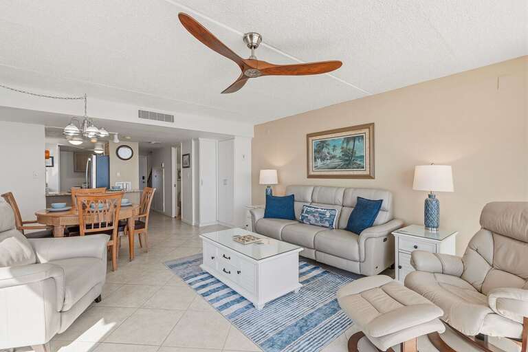 Relax in a bright, open living and dining space with comfortable seating, coastal-inspired décor,