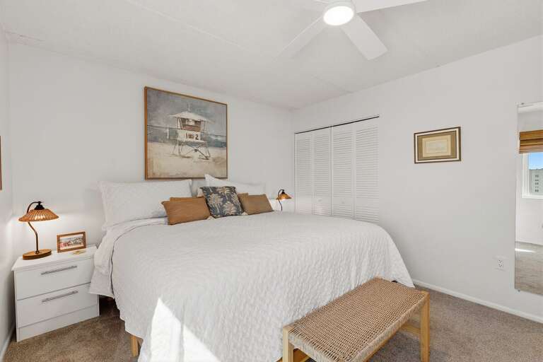 Rest comfortably in this inviting king bedroom featuring soft linens, ample closet space, a ceiling