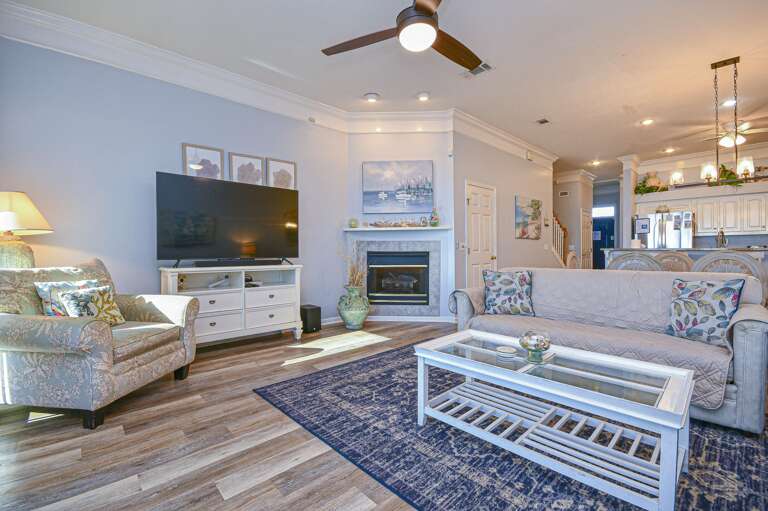 Cozy living room with fireplace and open kitchen access