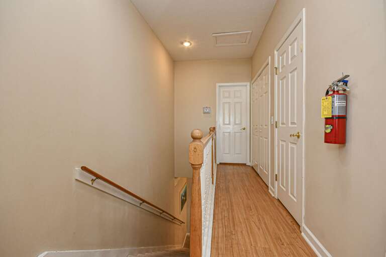 Bright, spacious hallway with warm wood flooring and natural light