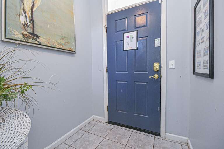 Welcoming entryway with stylish blue door and natural light