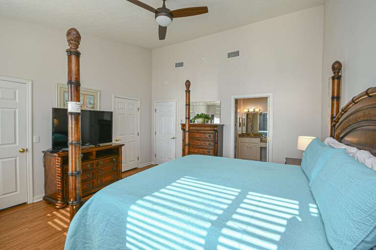 Sunlit bedroom with classic wooden accents and cozy comfort
