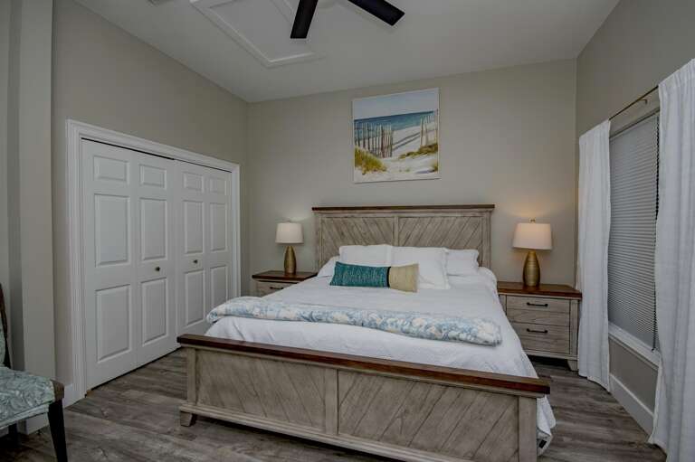 Cozy bedroom retreat with serene coastal artwork and soft lighting