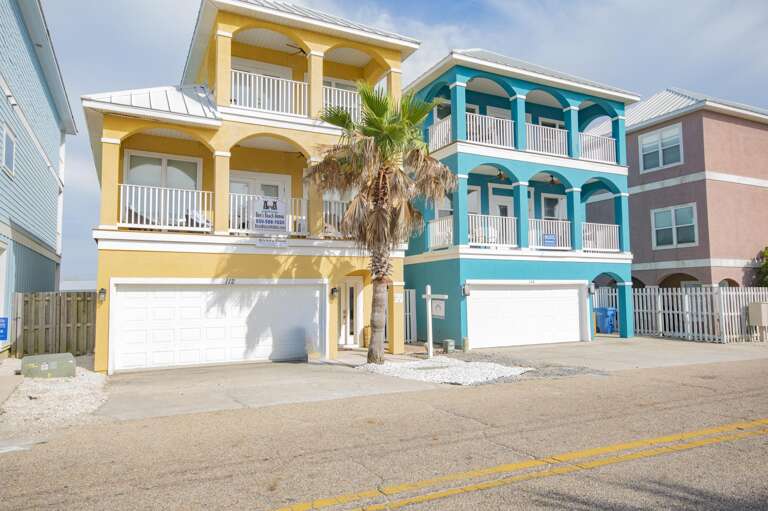 Colorful coastal townhomes with spacious balconies and palm trees