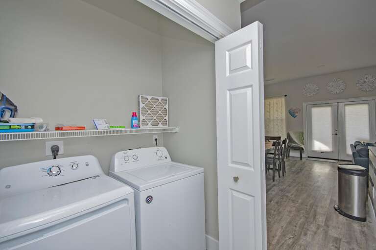 Bright, efficient laundry room with modern appliances and storage