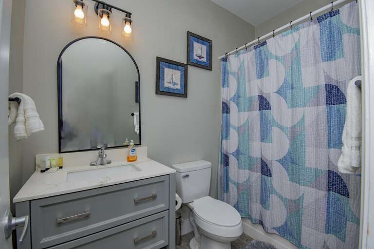 Bright bathroom with modern vanity and colorful shower curtain