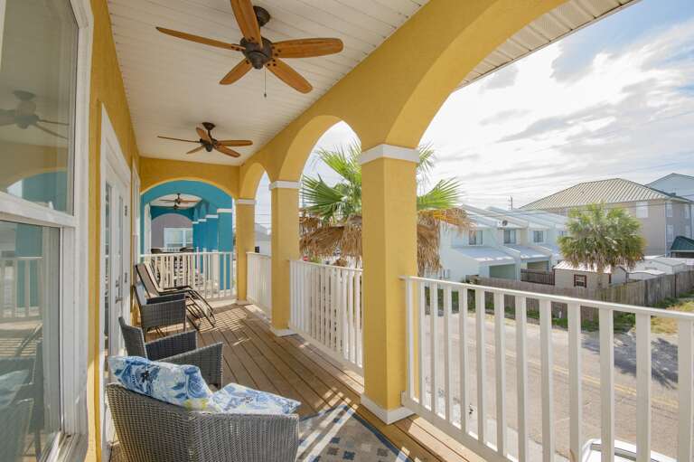 Sunny covered porch with cozy seating and scenic views